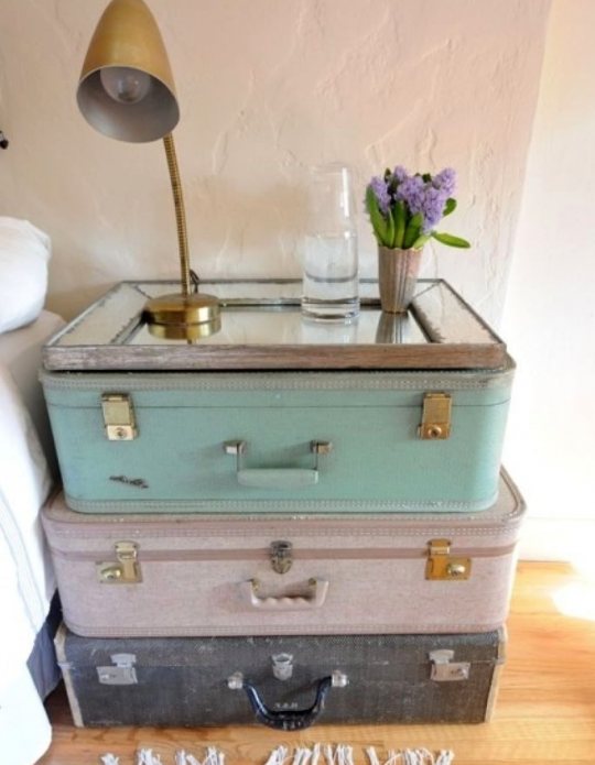 Bedside table with suitcases and mirrors