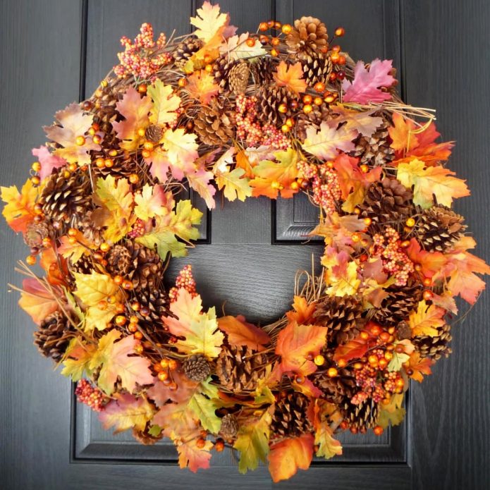 Luxurious wreath of autumn leaves and cones.